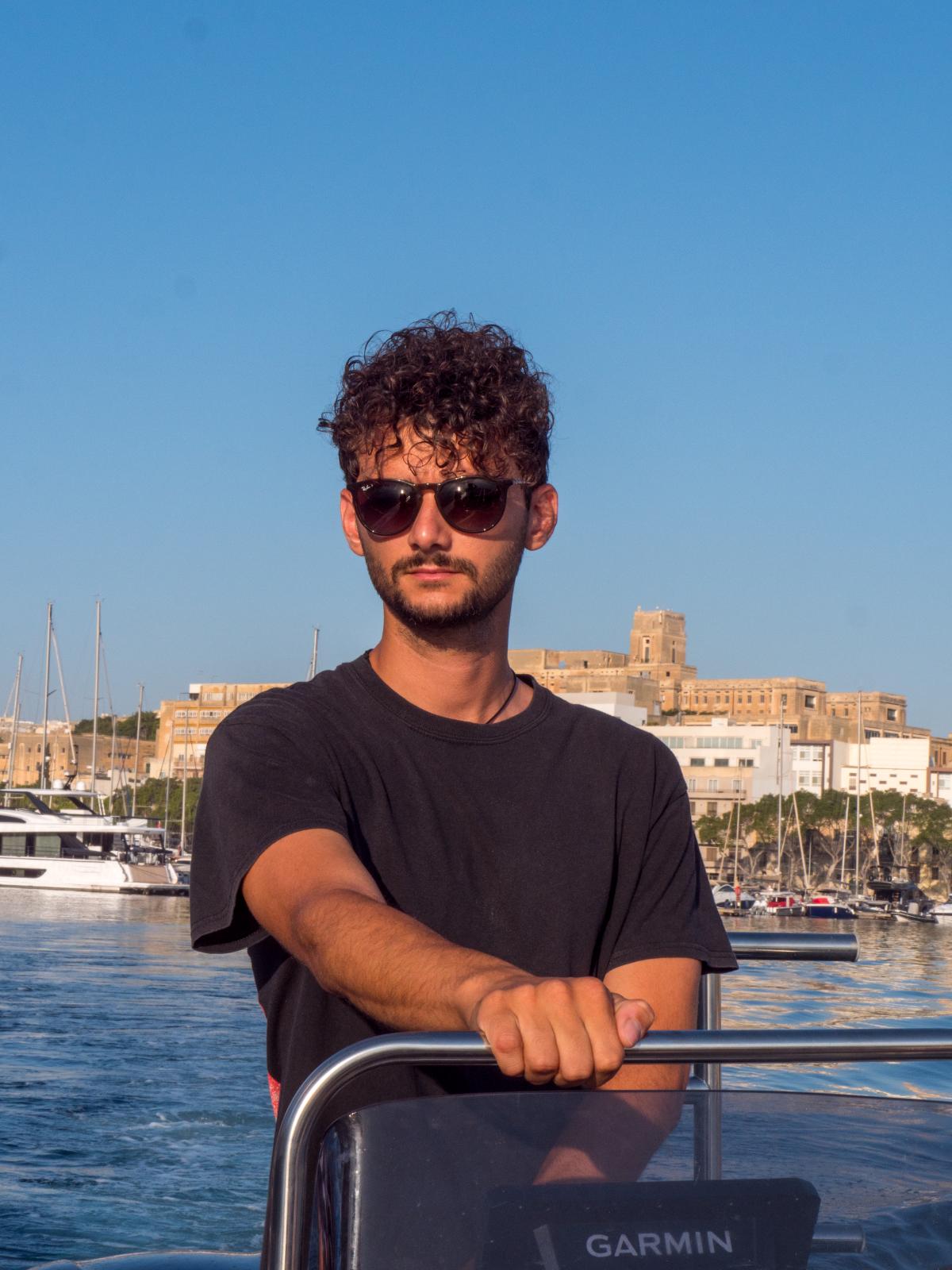 Team member on a boat at sunset